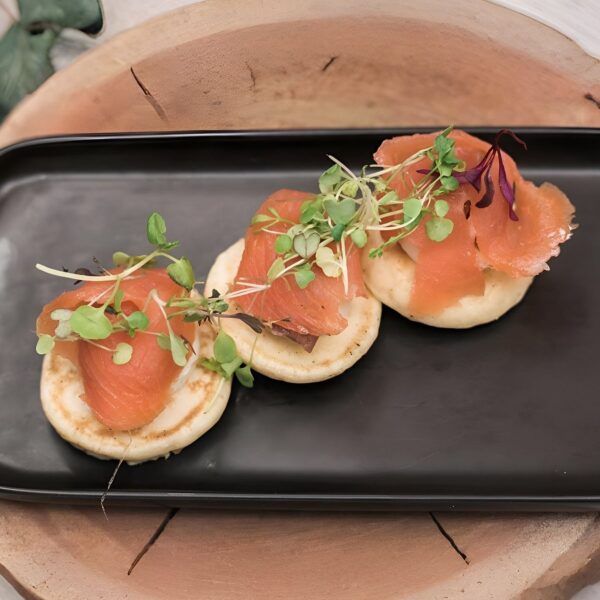 Blinis with smoked salmon, dill caper cream cheese and micro herbs