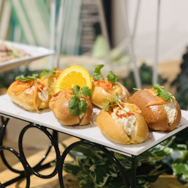 Brioche mini oval bun with Vietnamese pulled poached chicken with pickled carrot, coriander & sriracha aioli